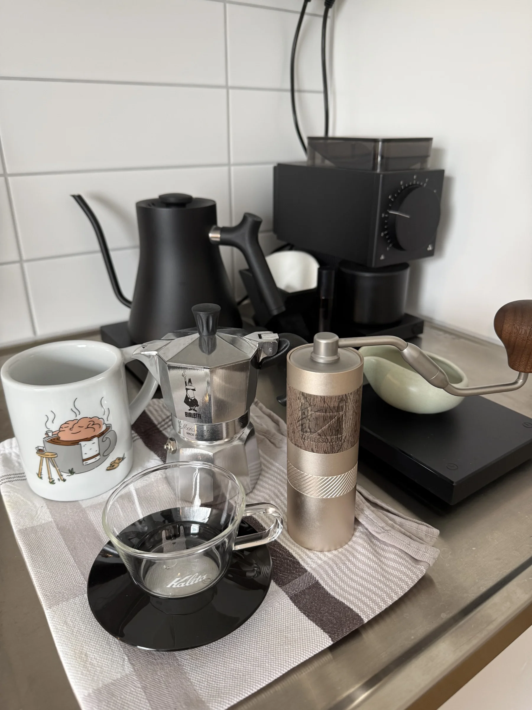 Coffee bar with grinder, kettle, filters and freshly measured beans.
